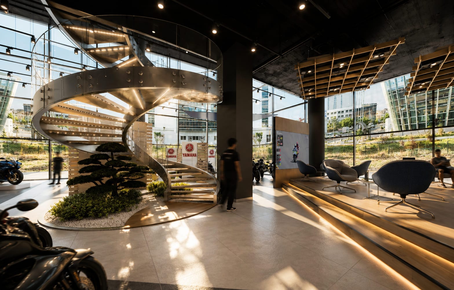Yamaha Premium Dealer showroom — cam cephe önünde aydınlatmalı çelik spiral merdiven ve iç bahçe düzenlemesi